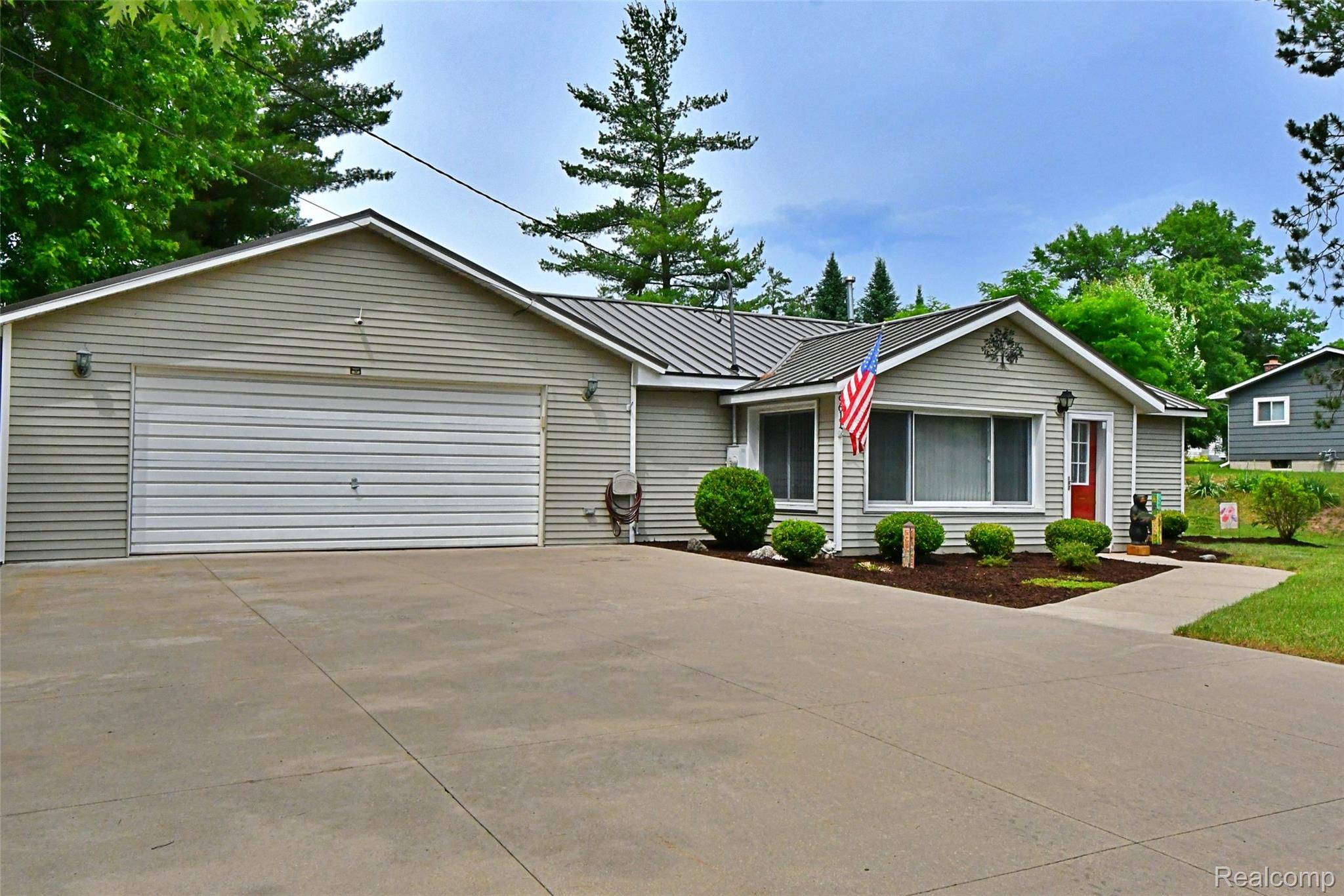 9611 Monroe Road St. Helen, MI 48656 - Photo 2 of 24 Ranch-style residence featuring light gray horizontal siding and a dark gray metal roof