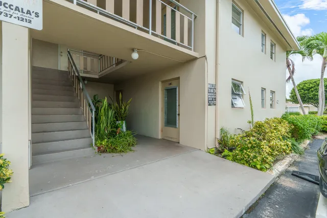 a kitchen with granite countertop white cabinets white stainless steel appliances and a sink