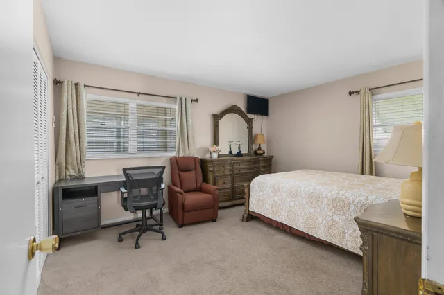 a bathroom with a granite countertop toilet sink and mirror