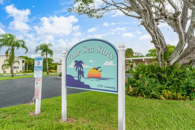 a outdoor space with lots of table chairs and potted plants