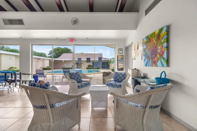 a view of pool with small yard and a large tree