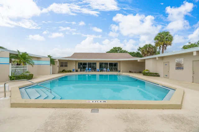 a living room with furniture a table and a bookshelf