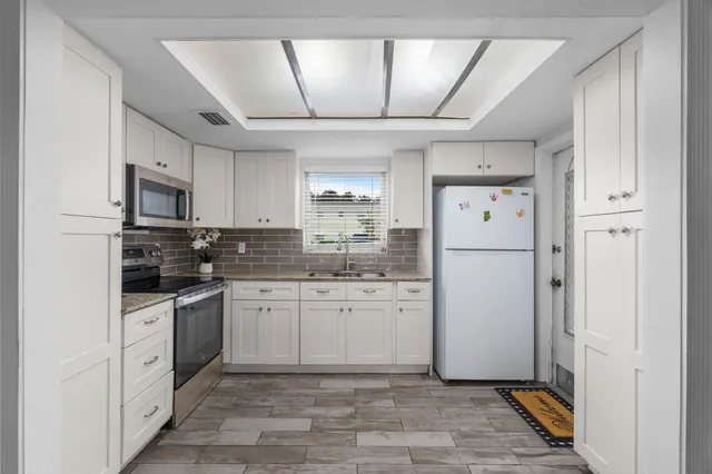 a view of a dining room with furniture and a potted plant