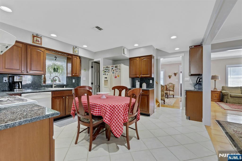 19 Hamilton Avenue Kearny, NJ 07032 - Photo 13 of 33 a kitchen with granite countertop a refrigerator and a stove top oven