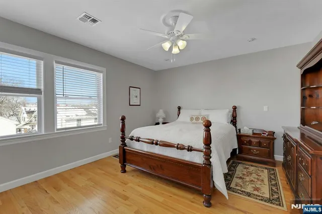 a bedroom with a bed chairs and a window