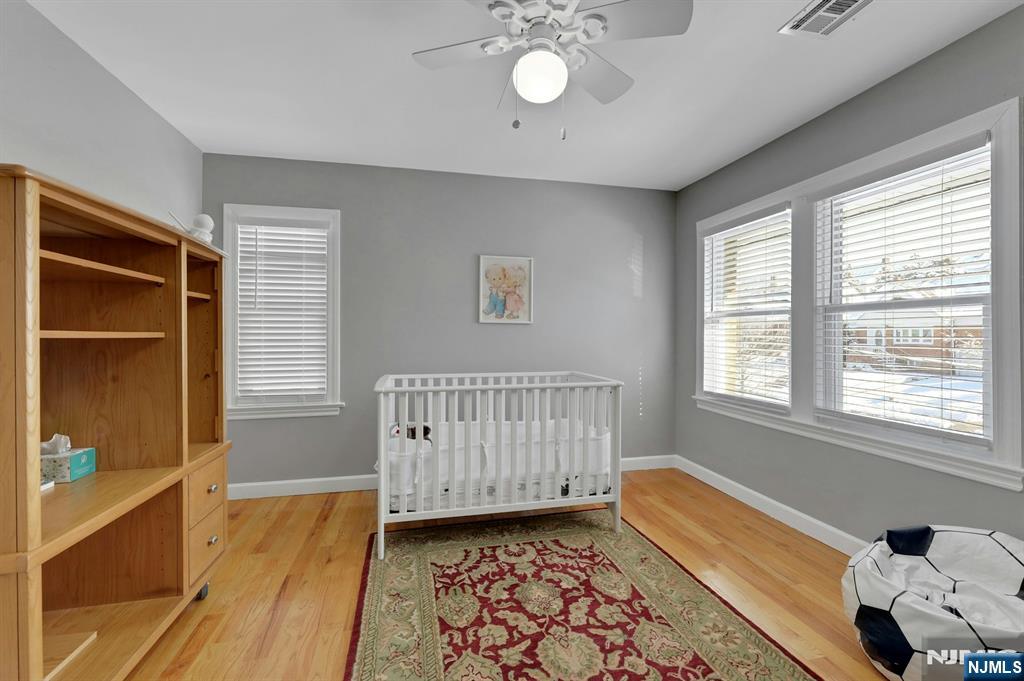 19 Hamilton Avenue Kearny, NJ 07032 - Photo 24 of 33 a view of an empty room with a window and wooden floor