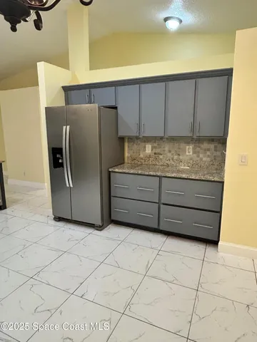a kitchen with stainless steel appliances granite countertop a sink and cabinets