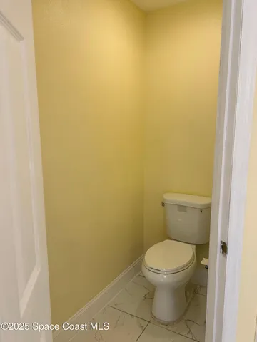 a view of a room with wooden floor and fence