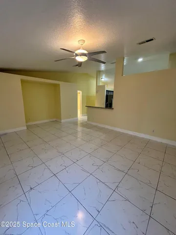 an empty room with projector and bathroom