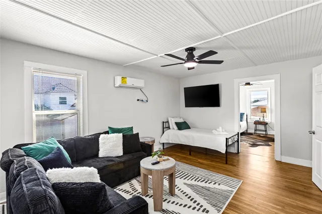 a living room with furniture and wooden floor
