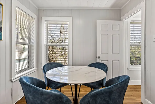 a view of a dining room with furniture and wooden floor