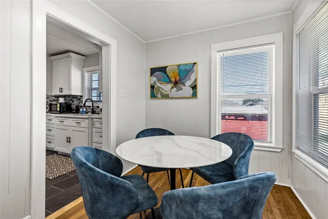 a view of a dining room with furniture and window