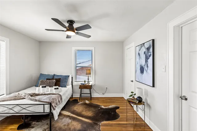 a bedroom with a bed and wooden floor