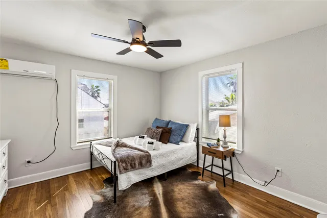 a bedroom with a bed and wooden floor
