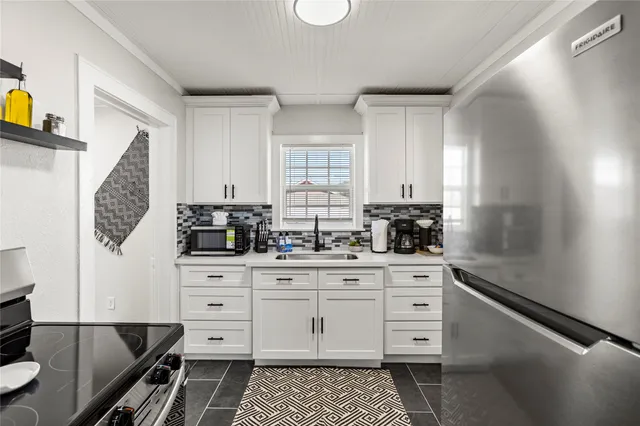 a kitchen with stainless steel appliances a cabinets and a counter top space