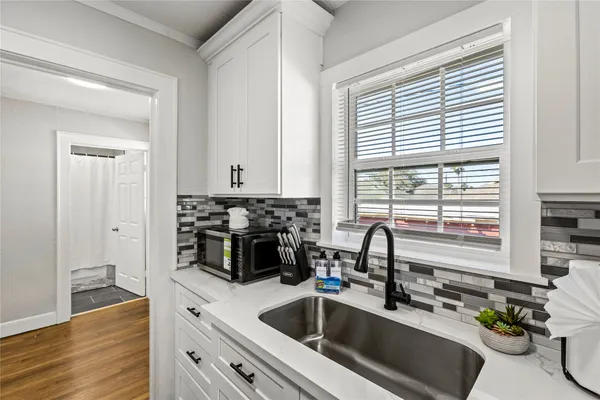 a kitchen with a sink a counter and cabinets