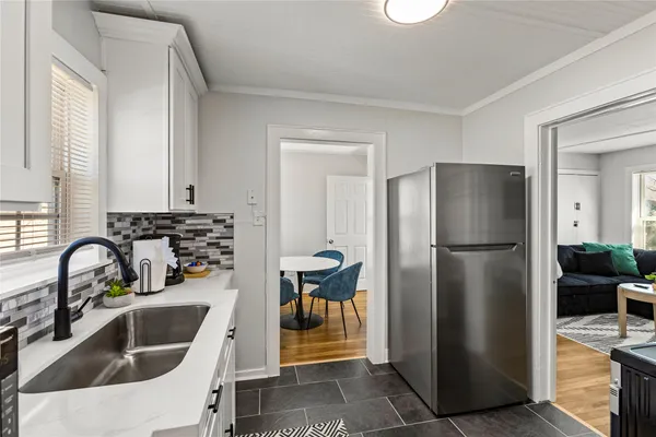 a kitchen with a refrigerator sink and cabinets