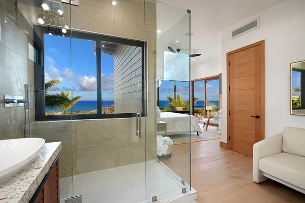 a spacious bathroom with a granite countertop tub sink and glass door