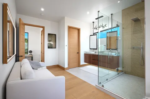 a spacious bathroom with a double vanity sink a mirror and shower