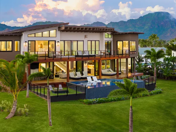 a view of a house with a yard deck and furniture