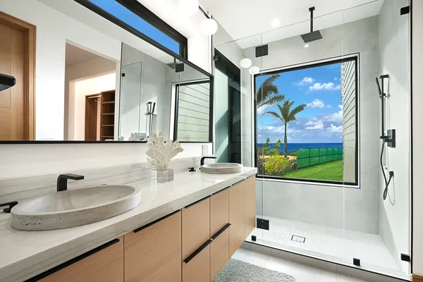 a bathroom with a tub a sink and mirror