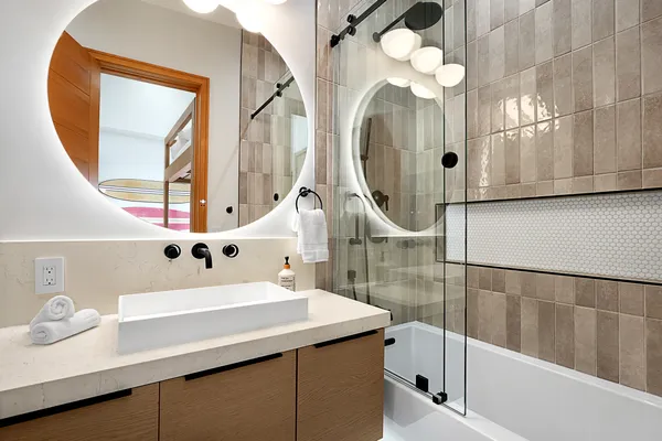 a bathroom with a sink a mirror and a shower