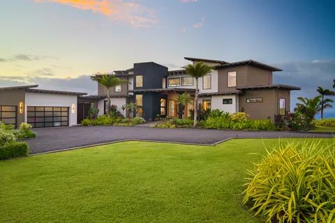 a view of house with yard and outdoor seating