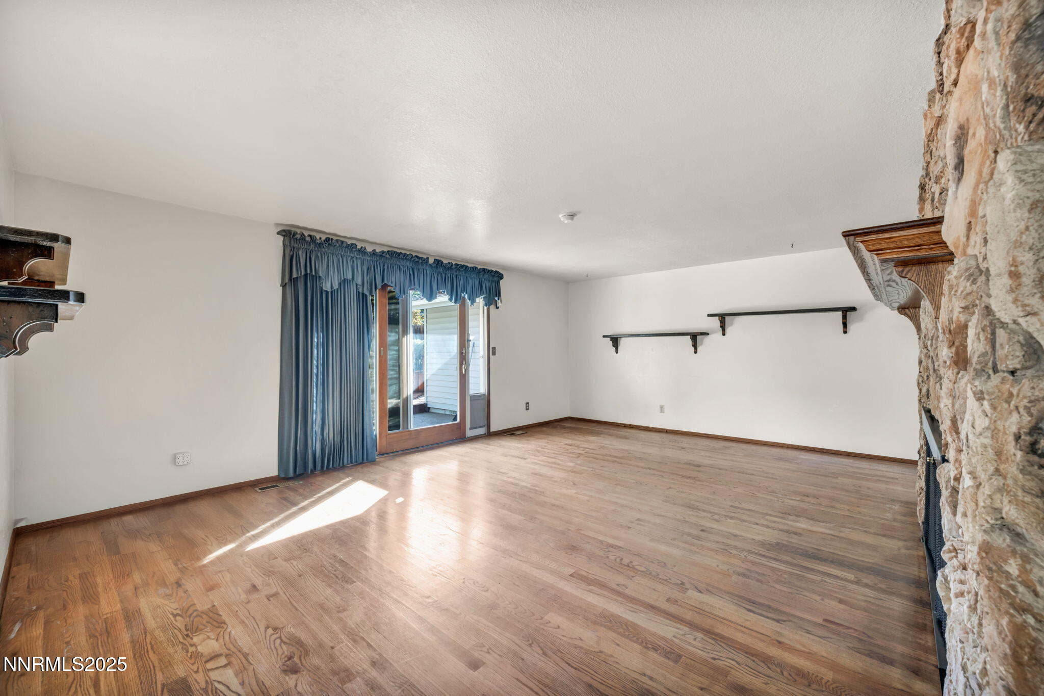 3370 Shawnee Circle Reno, NV 89502 - Photo 7 of 78 a view of an empty room with wooden floor and a window