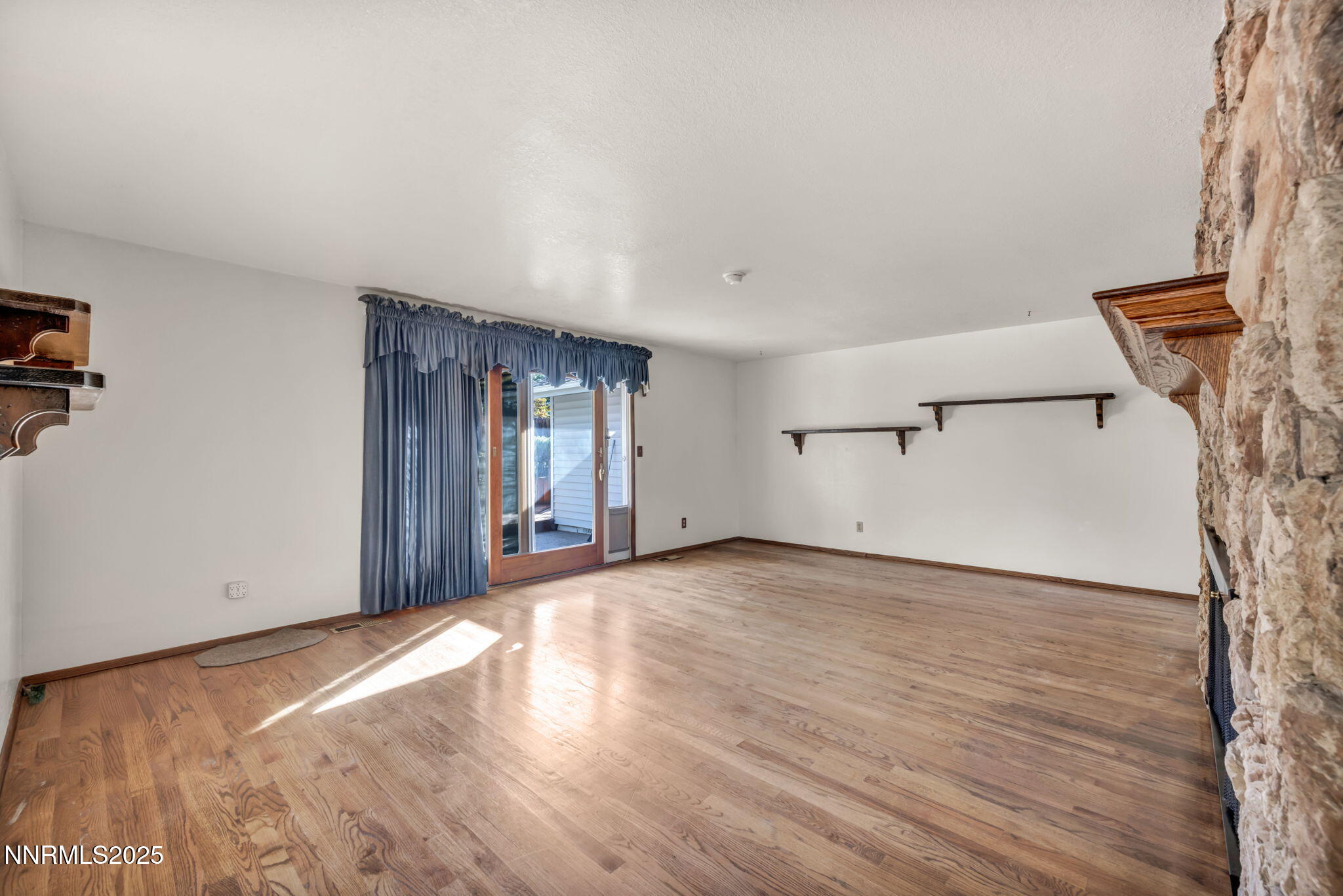 3370 Shawnee Circle Reno, NV 89502 - Photo 9 of 78 an empty room with wooden floor and windows