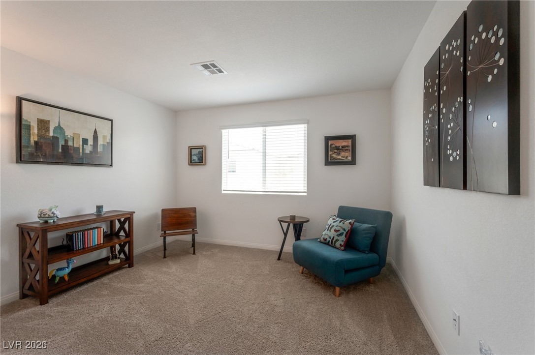 12348 Golden Wreath Road, Unit 1 Las Vegas, NV 89183 - Photo 17 of 37 Sitting room featuring light carpet and baseboards