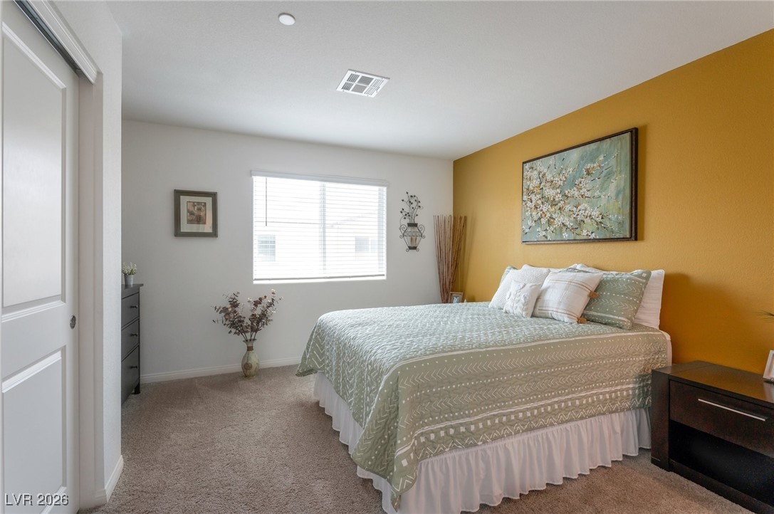 12348 Golden Wreath Road, Unit 1 Las Vegas, NV 89183 - Photo 21 of 37 Bedroom with light carpet and a closet