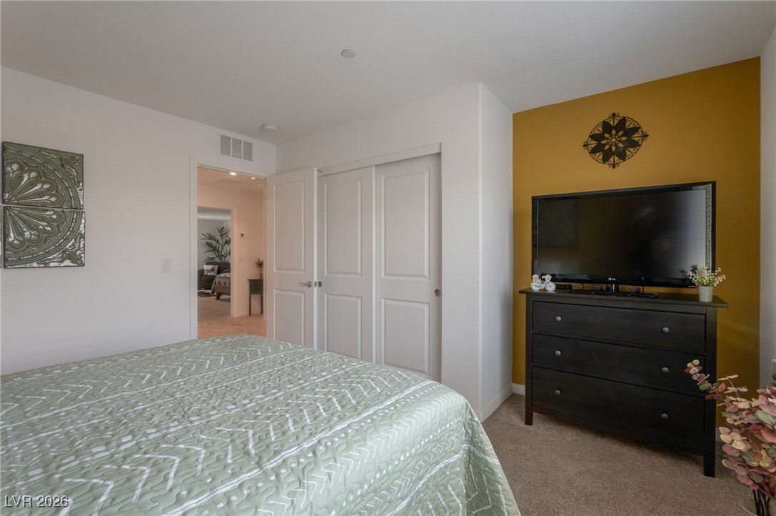 12348 Golden Wreath Road, Unit 1 Las Vegas, NV 89183 - Photo 22 of 37 Bedroom featuring light carpet and a closet