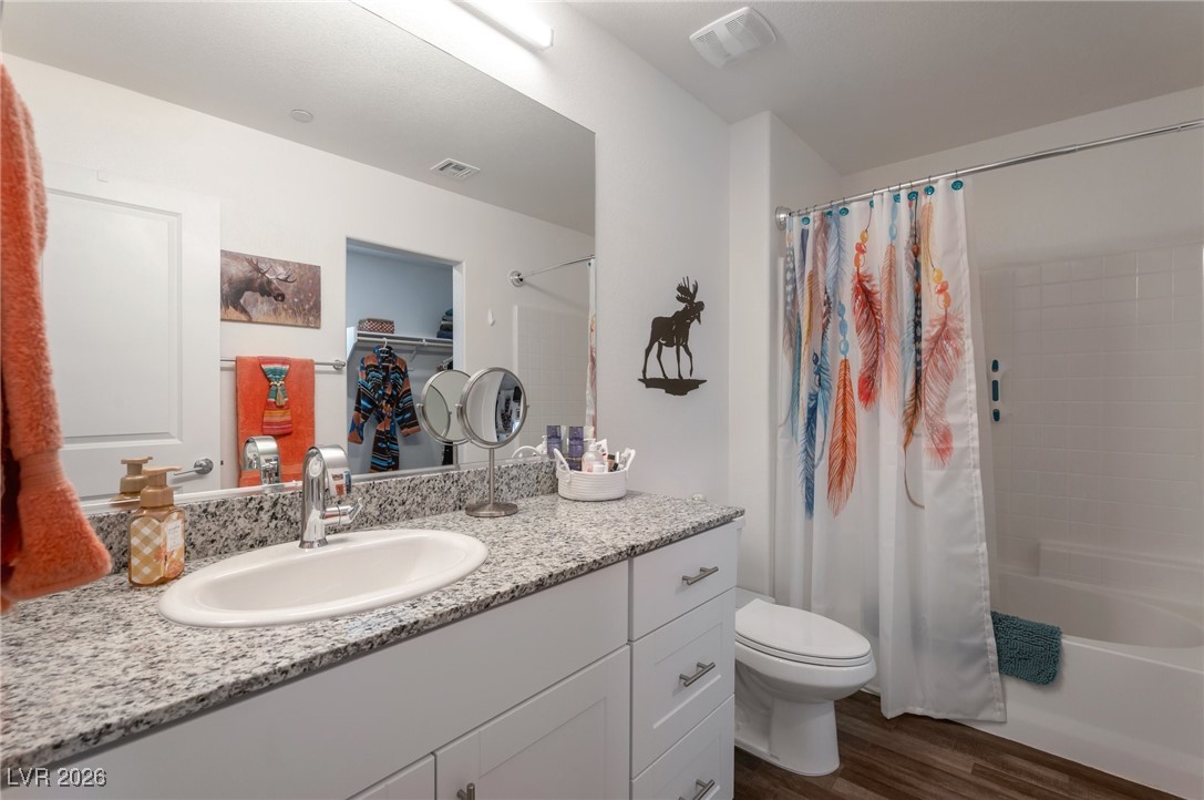 12348 Golden Wreath Road, Unit 1 Las Vegas, NV 89183 - Photo 24 of 37 Full bath with shower / bath combination with curtain, vanity, and dark wood finished floors