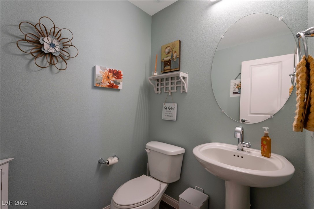 12348 Golden Wreath Road, Unit 1 Las Vegas, NV 89183 - Photo 26 of 37 Half bathroom with toilet and a textured wall