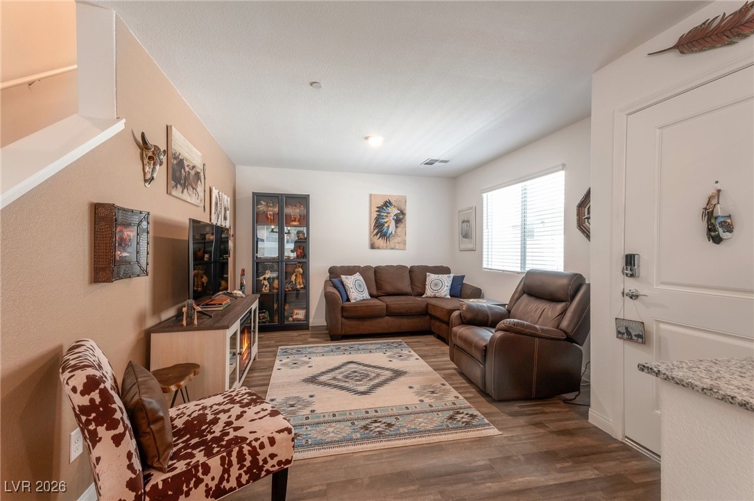 12348 Golden Wreath Road, Unit 1 Las Vegas, NV 89183 - Photo 10 of 37 Living area with dark wood-type flooring