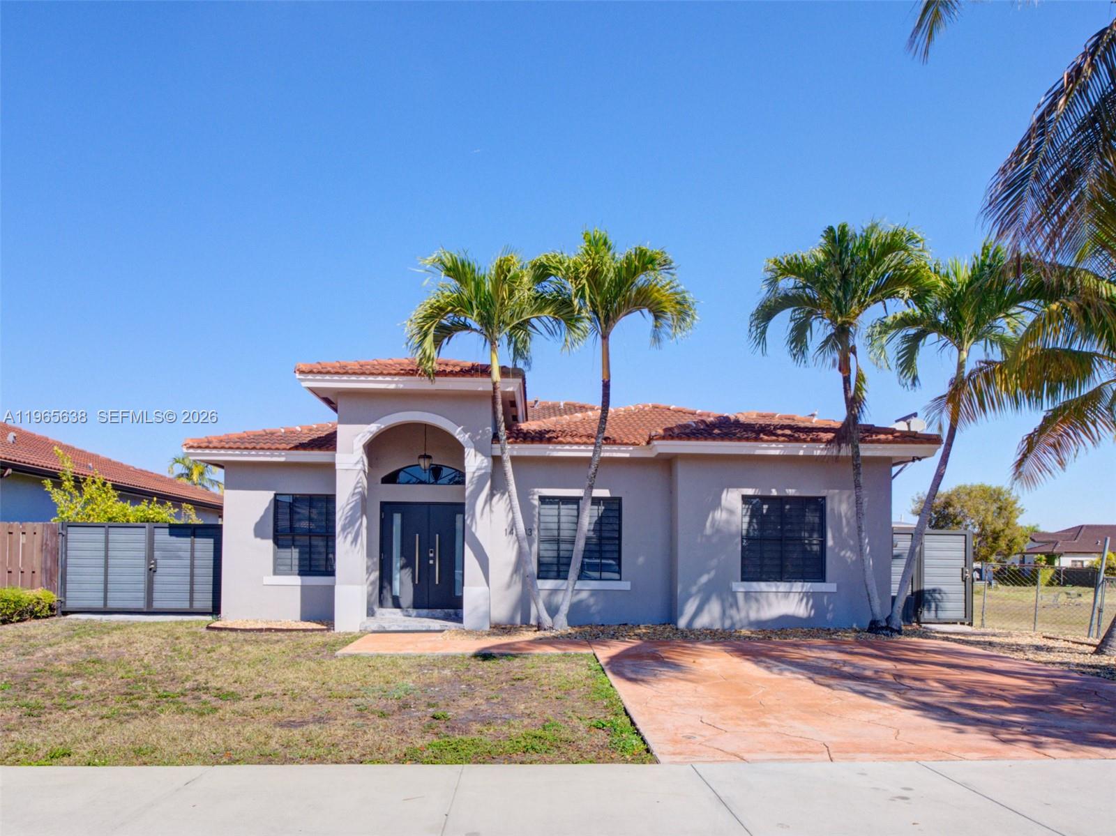 14833 Southwest 35th Lane Miami, FL 33185 - Photo 11 of 45 a view of a house with a yard and potted plants
