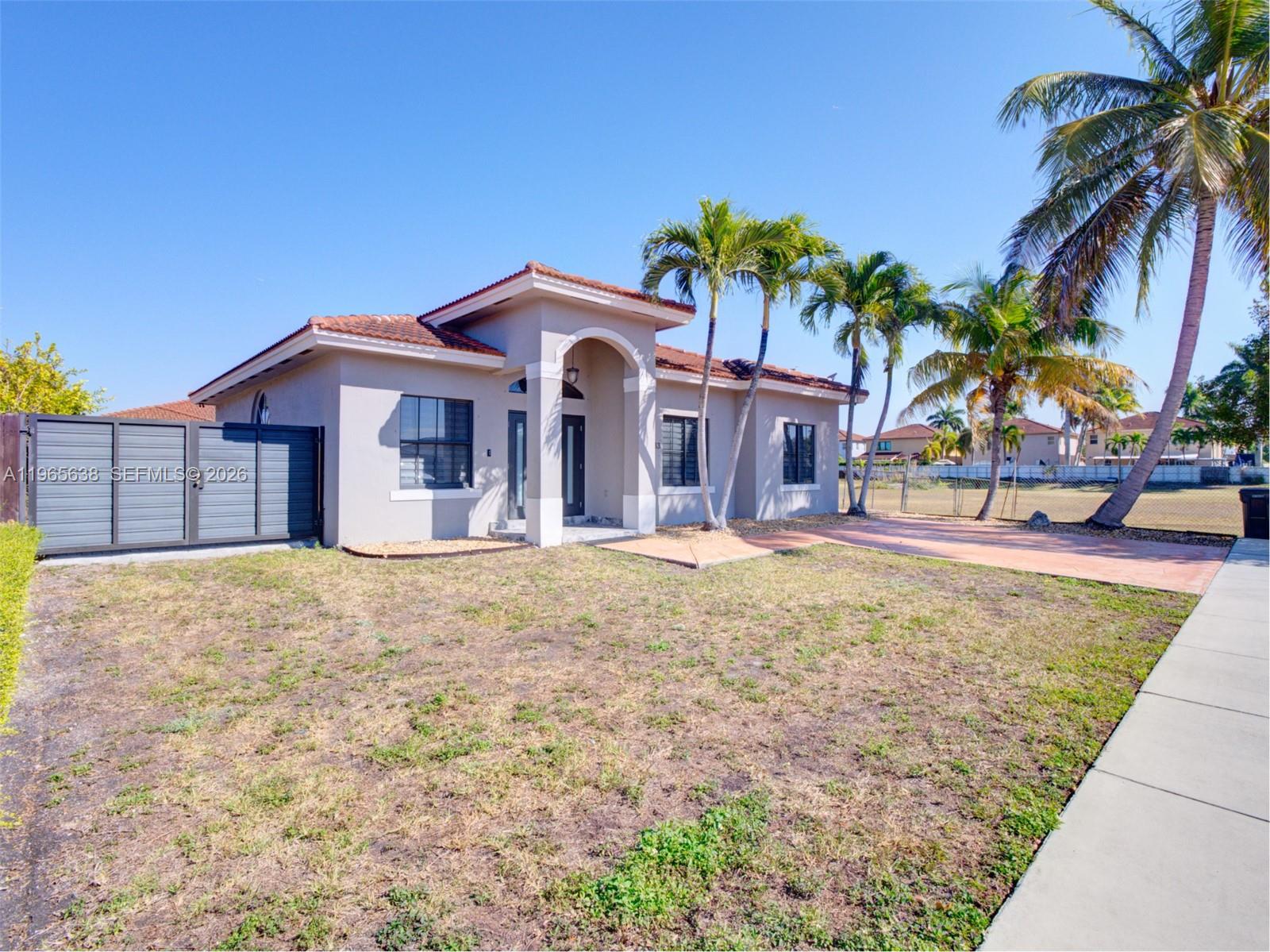 14833 Southwest 35th Lane Miami, FL 33185 - Photo 12 of 45 a front view of a house with a yard