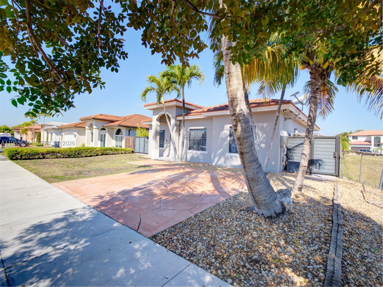 14833 Southwest 35th Lane Miami, FL 33185 - Photo 13 of 45 a front view of a house with a yard