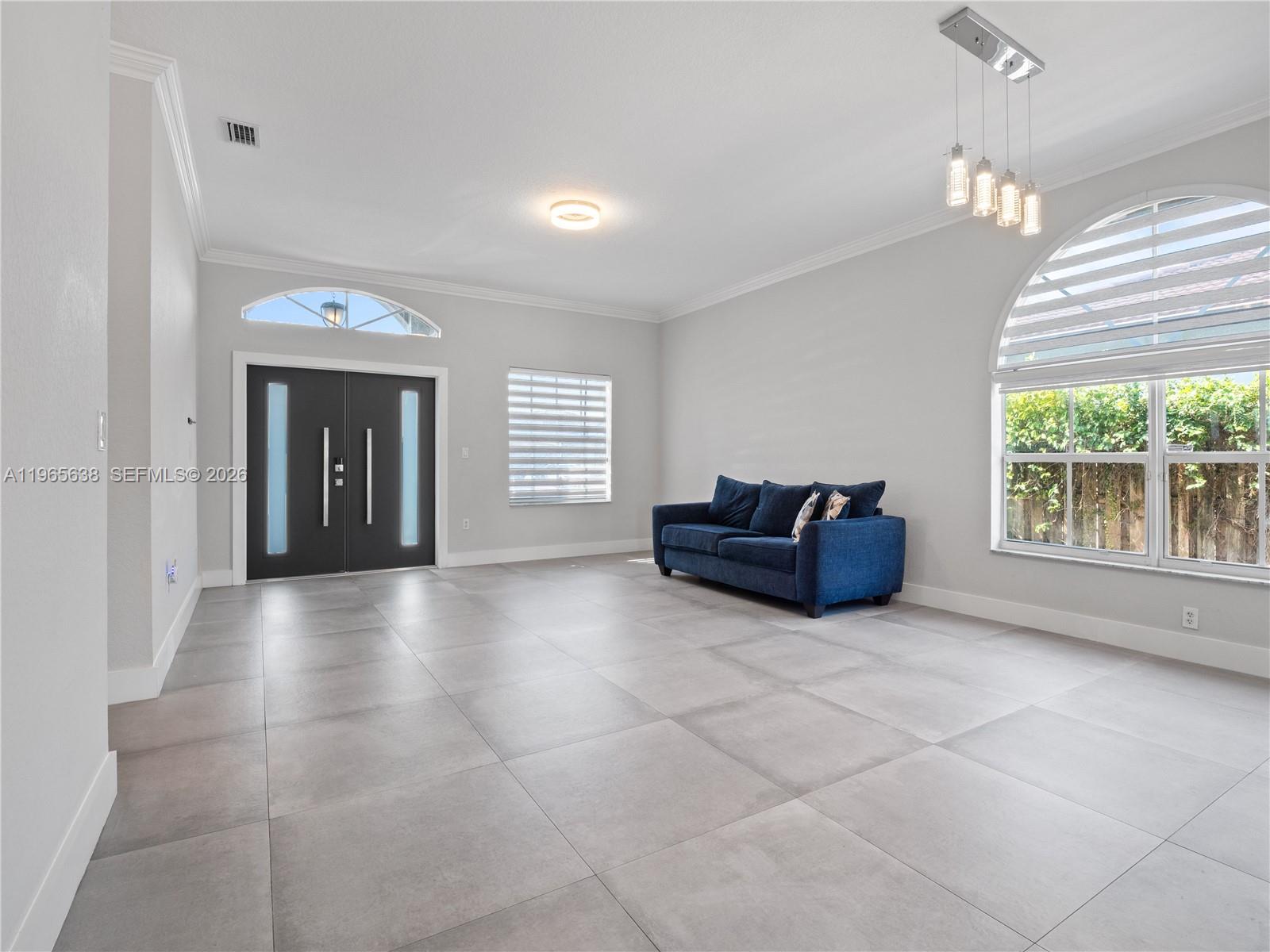 14833 Southwest 35th Lane Miami, FL 33185 - Photo 18 of 45 a living room with furniture and a large window