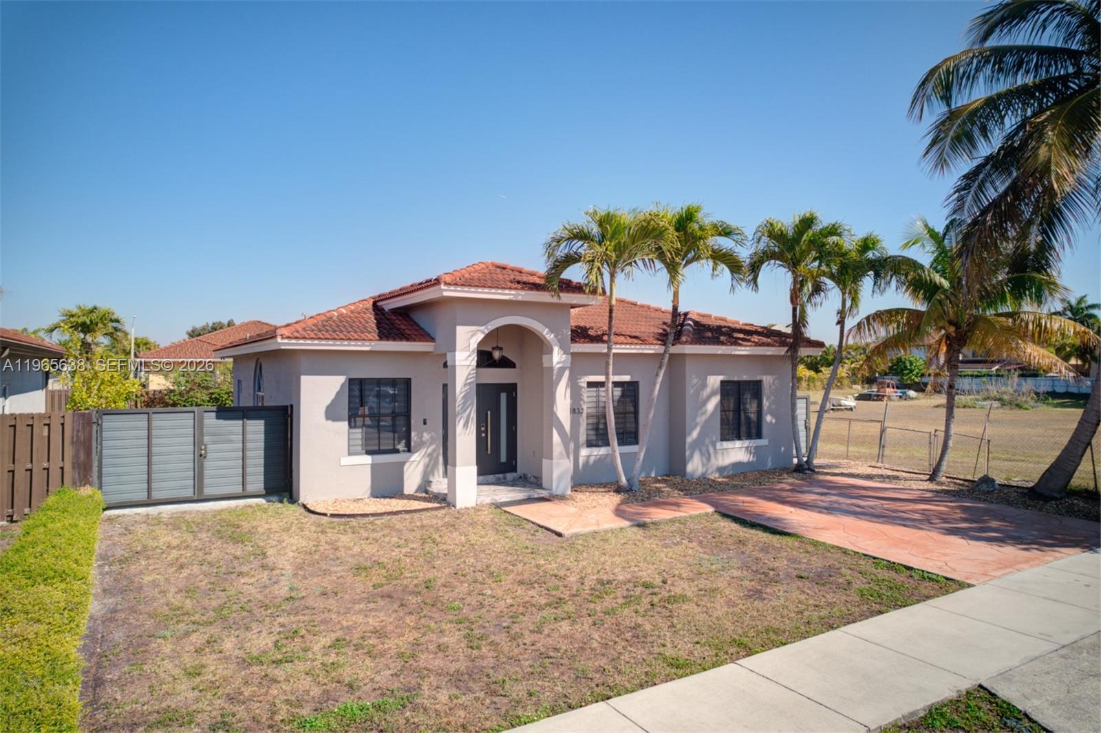 14833 Southwest 35th Lane Miami, FL 33185 - Photo 2 of 45 a front view of a house with a yard