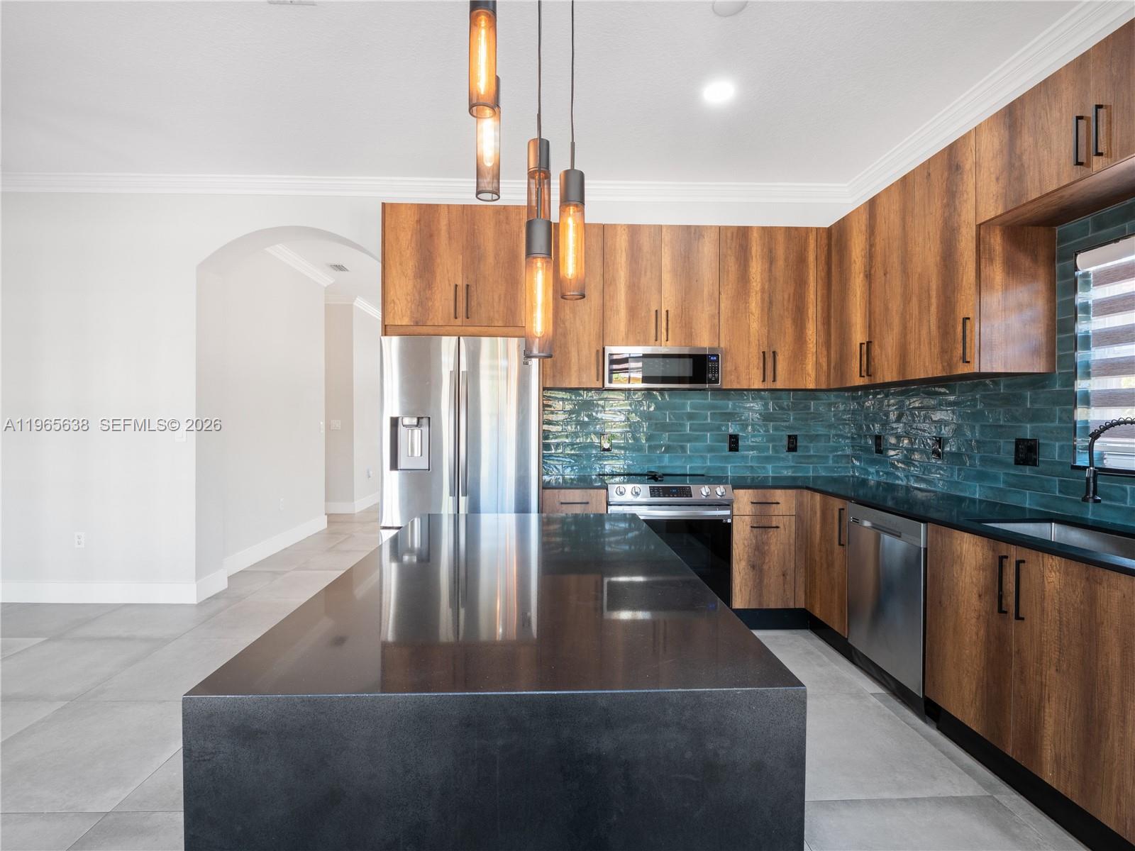 14833 Southwest 35th Lane Miami, FL 33185 - Photo 21 of 45 a kitchen with stainless steel appliances granite countertop a refrigerator a sink dishwasher with a dining table and chairs