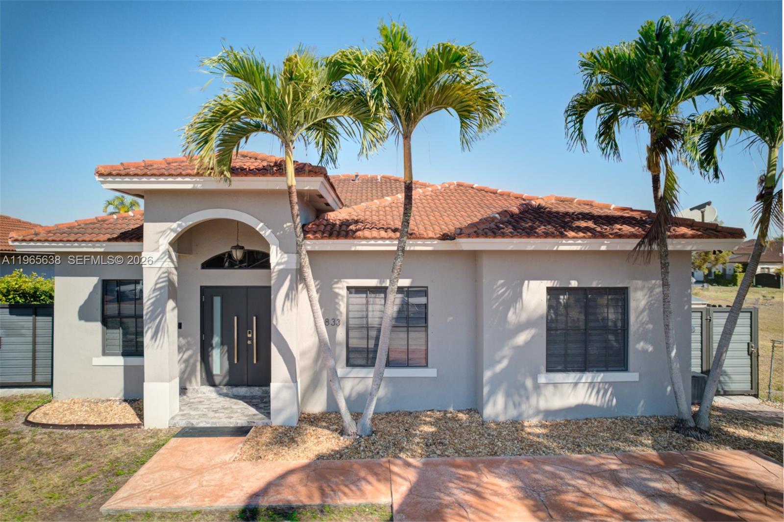 14833 Southwest 35th Lane Miami, FL 33185 - Photo 3 of 45 a front view of a house with garden