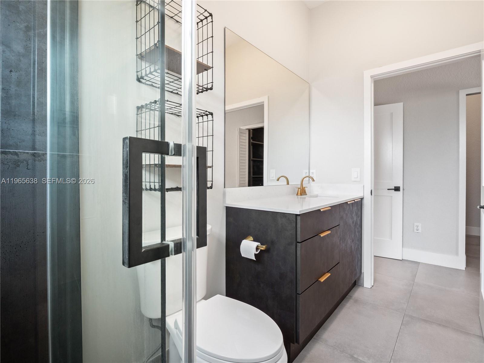 14833 Southwest 35th Lane Miami, FL 33185 - Photo 32 of 45 a bathroom with a sink vanity granite and toilet