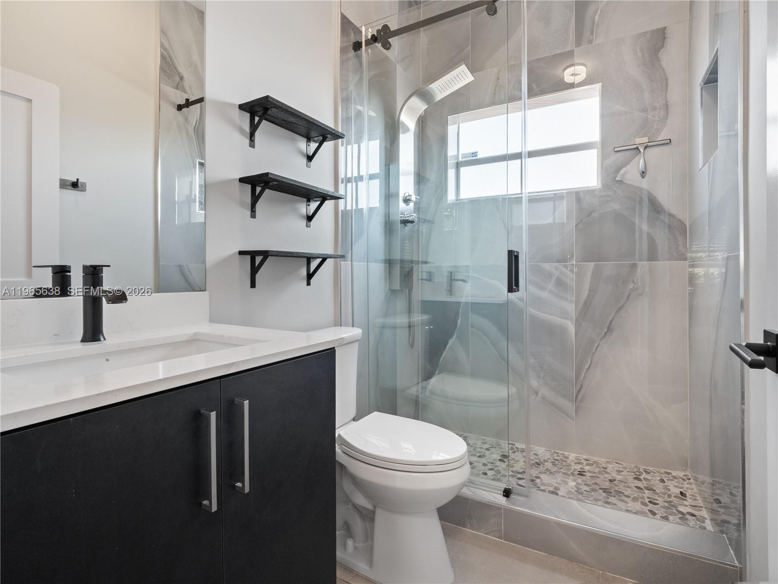 14833 Southwest 35th Lane Miami, FL 33185 - Photo 33 of 45 a bathroom with a sink a toilet and shower