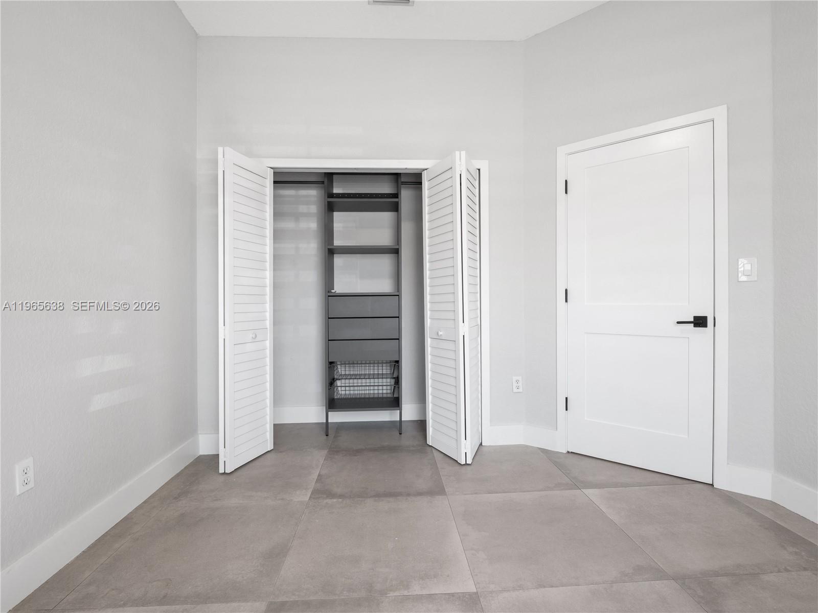 14833 Southwest 35th Lane Miami, FL 33185 - Photo 37 of 45 an empty room with closet and closet