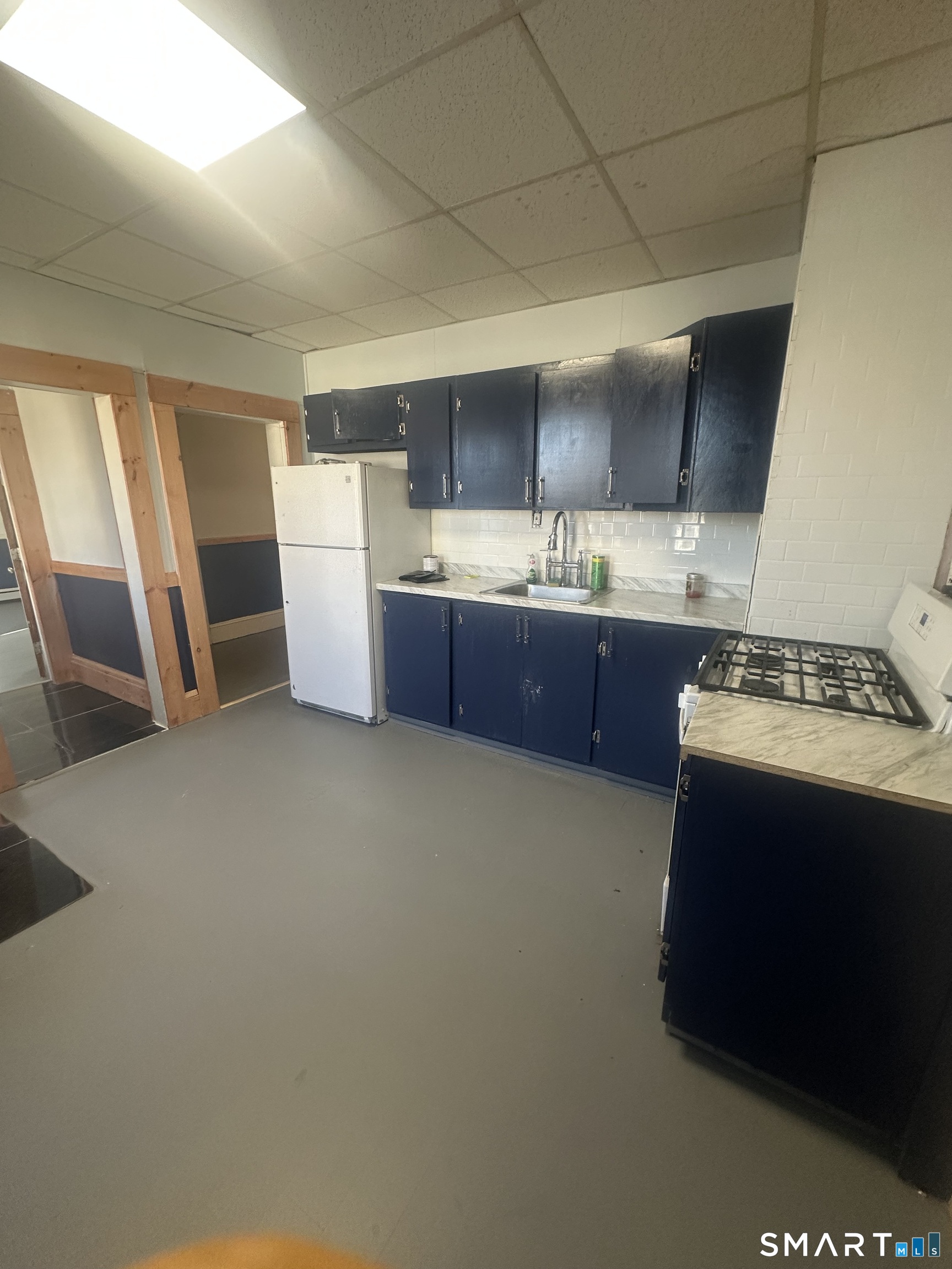 1365 East Main Street Bridgeport, CT 06608 - Photo 13 of 40 a room with kitchen island granite countertop a sink stove and refrigerator