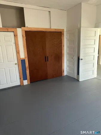 a view of entryway with a tub and door