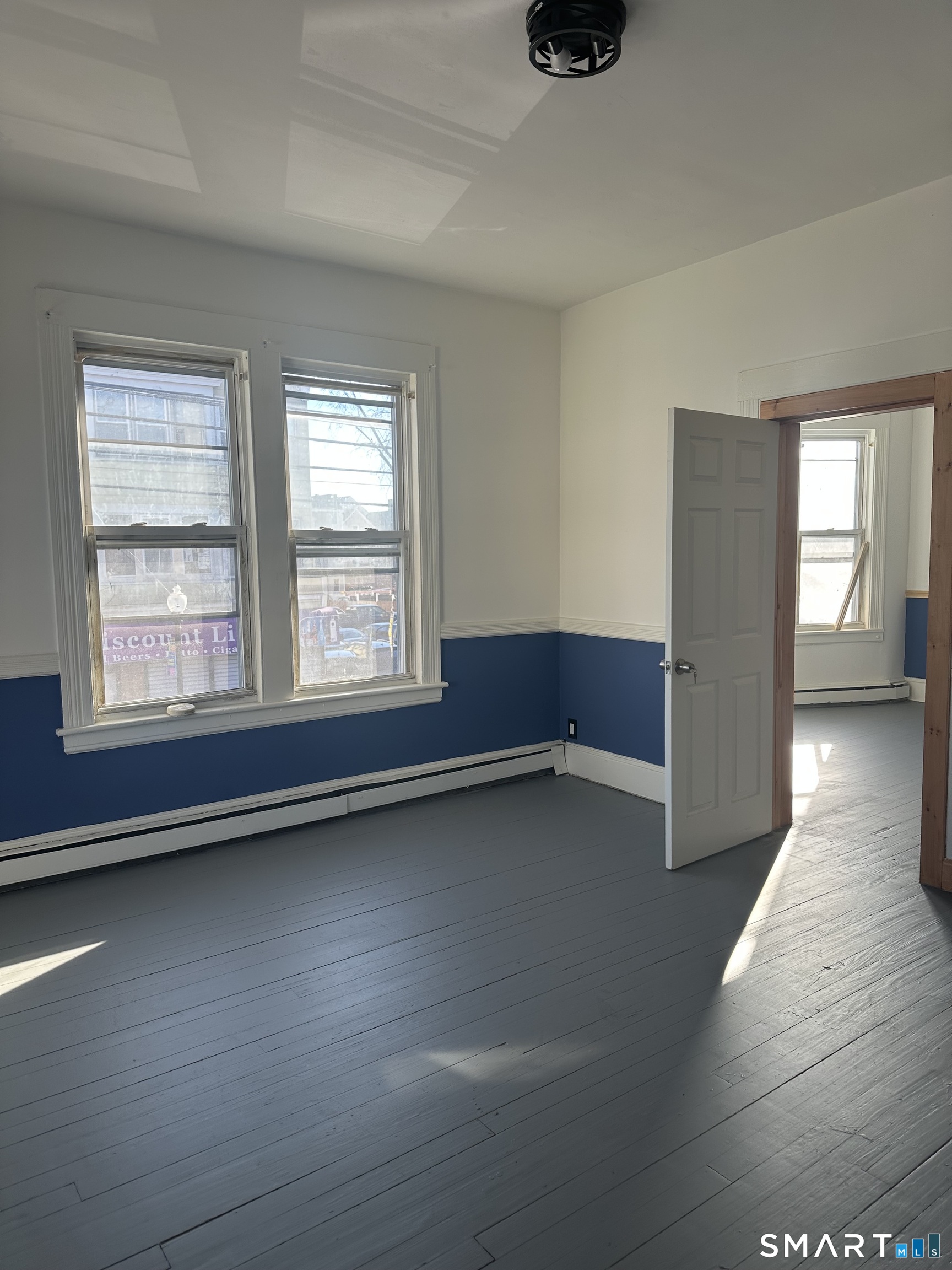 1365 East Main Street Bridgeport, CT 06608 - Photo 19 of 40 an empty room with wooden floor and windows