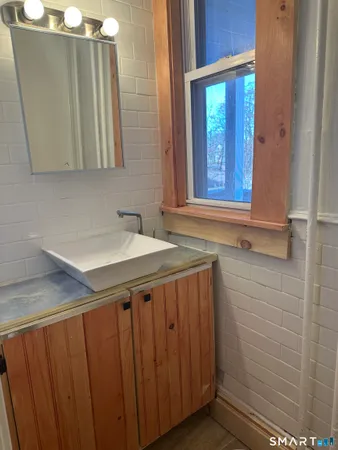 a large kitchen with kitchen island a large counter top space a sink stainless steel appliances and cabinets
