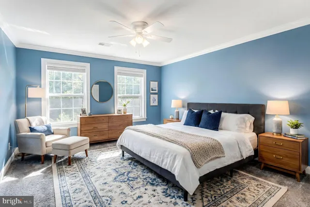 a spacious bedroom with a bed and wooden floor